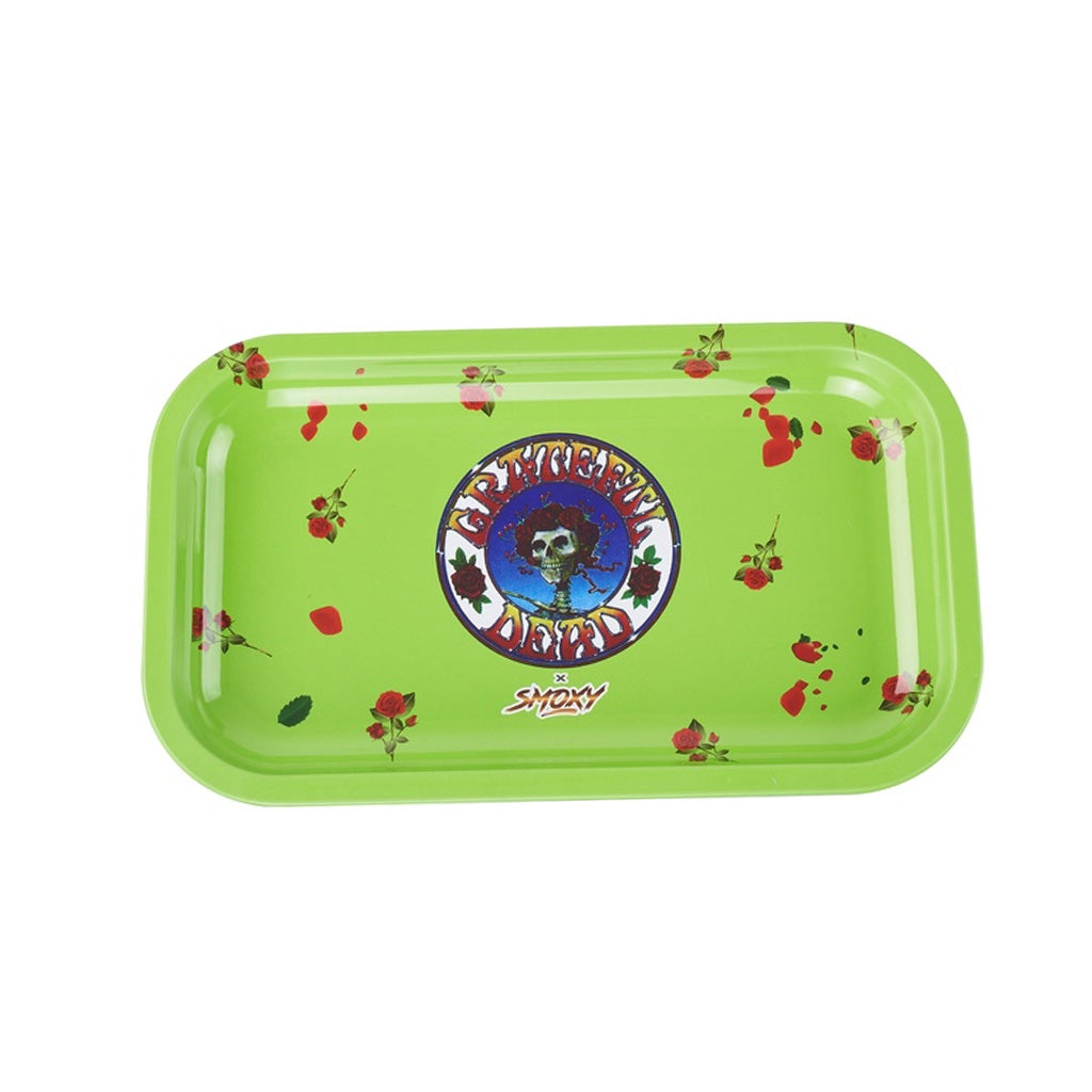 Rolling papers, tray, and brass accessories on slate